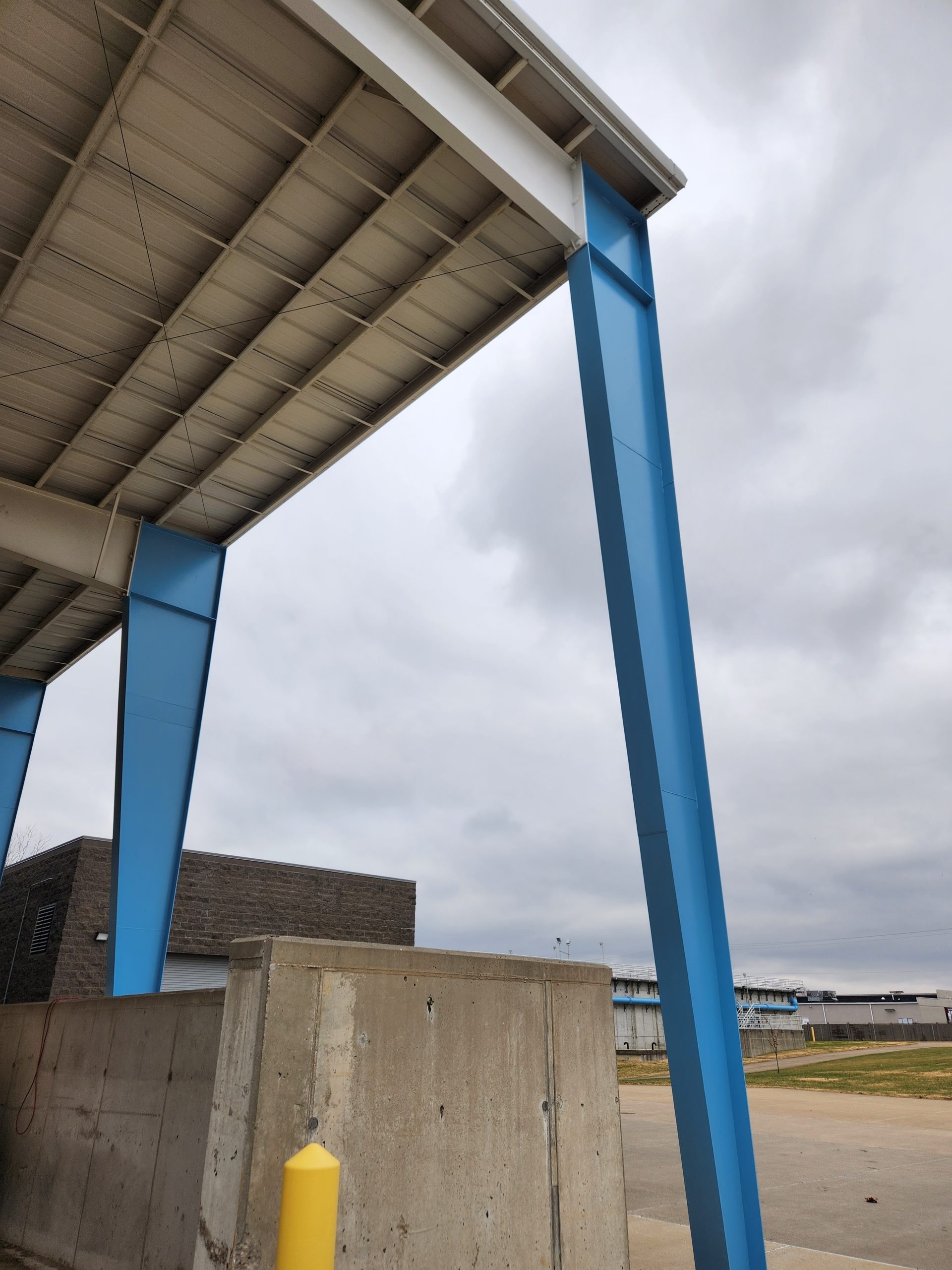 Piping and structural steel on the exterior of the plant's concrete basins.